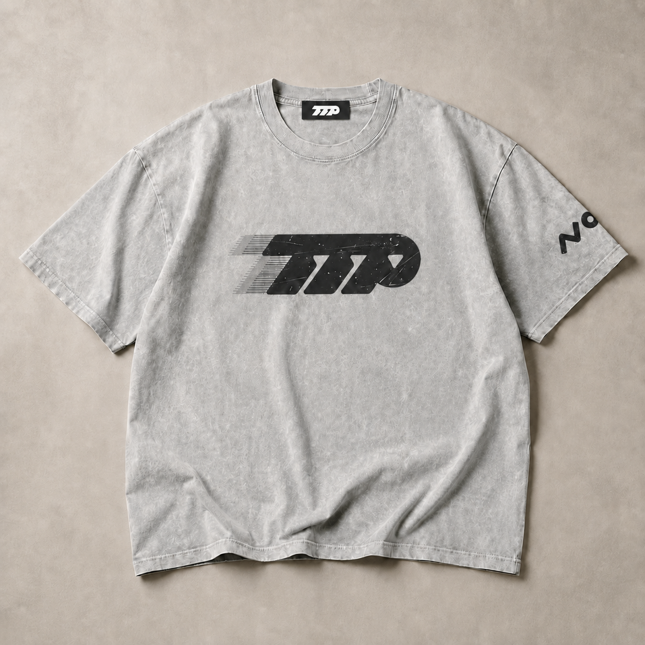 Grey tshirt flat lay on greige background 