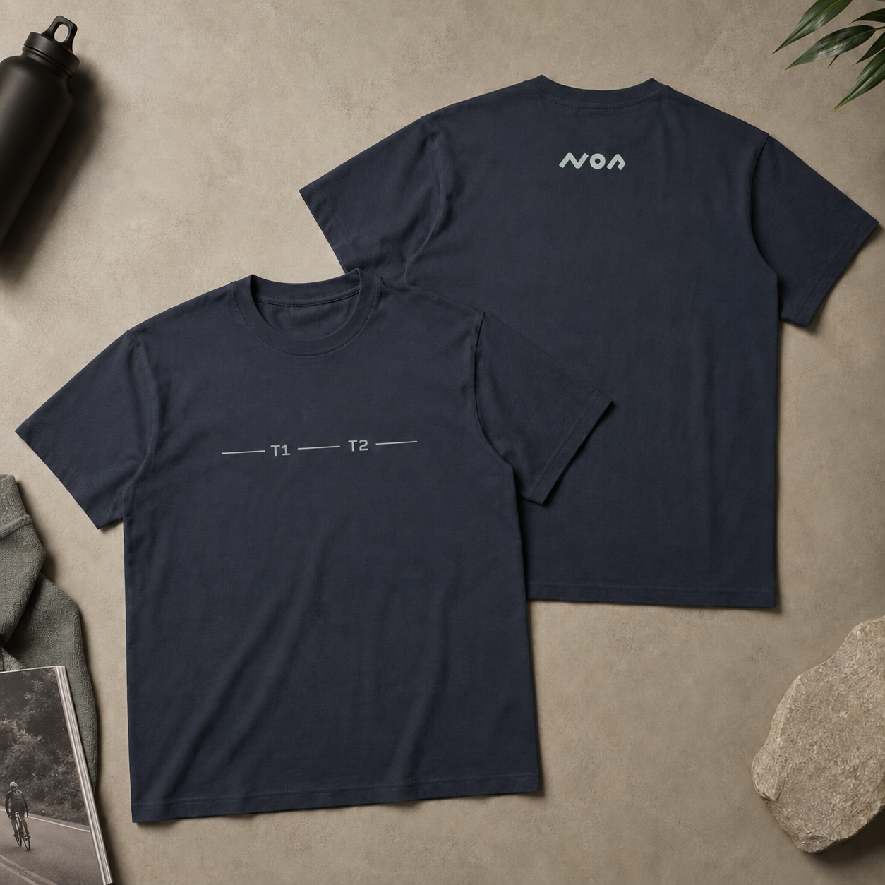 Top down image showing front and back of navy tshirt with graphics