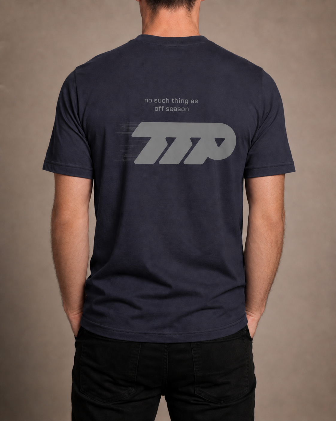 Male model showing back of navy tshirt with large graphic print